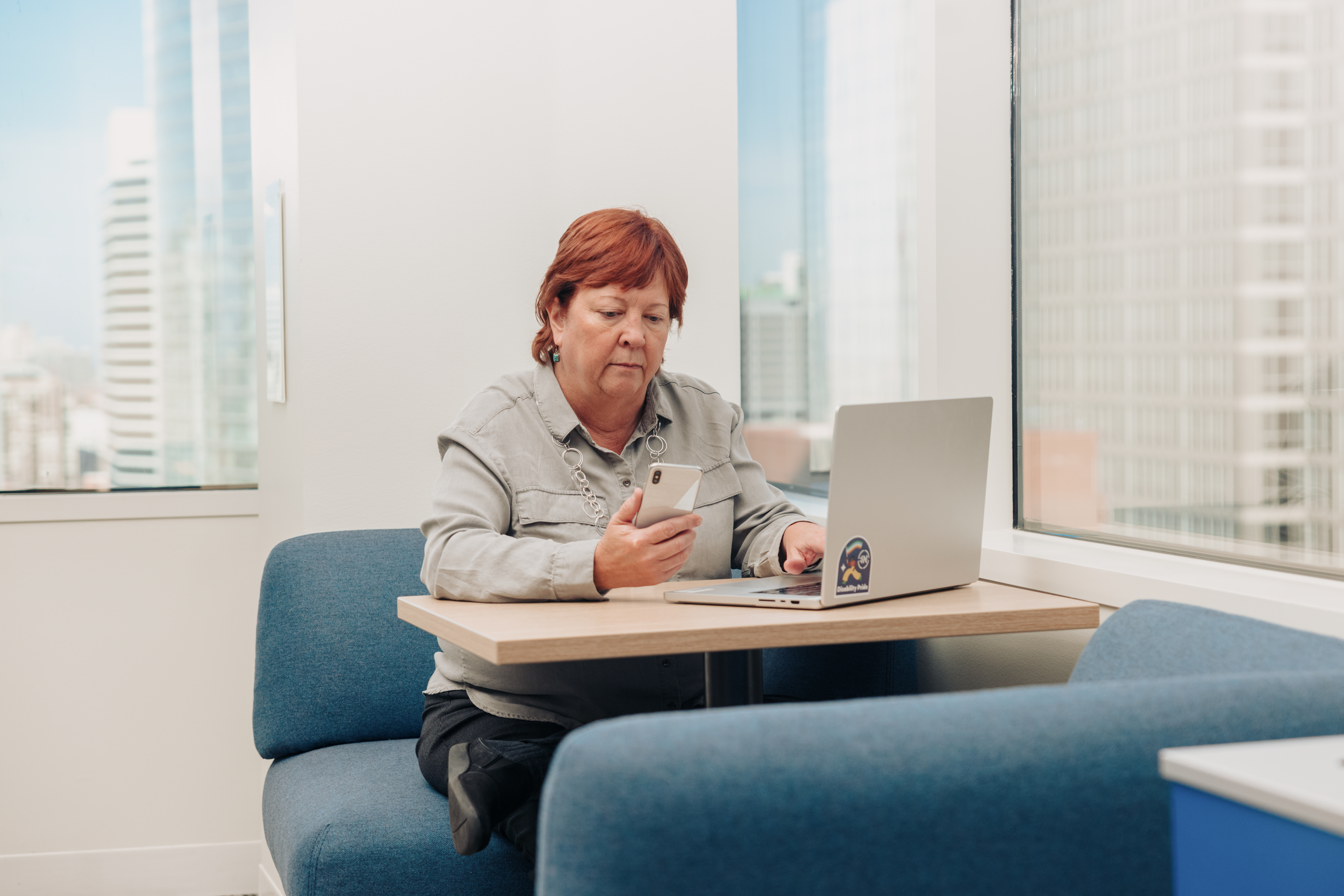 Professional working across multiple devices showcasing digital inclusion